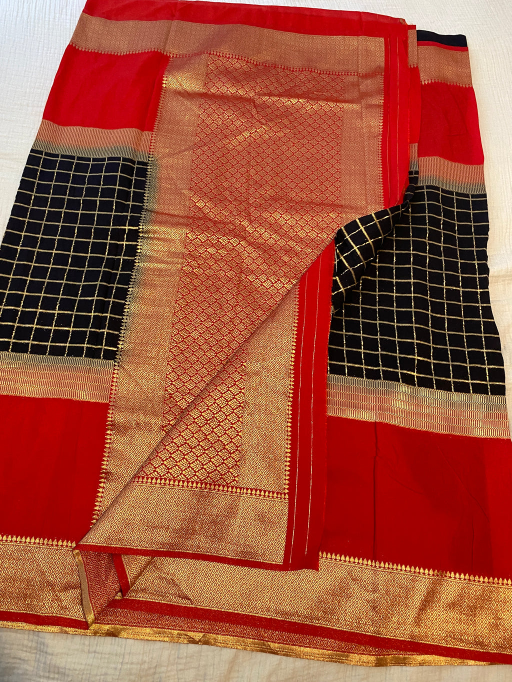 Georgette Saree in Black & Red with Gold Zari Checks